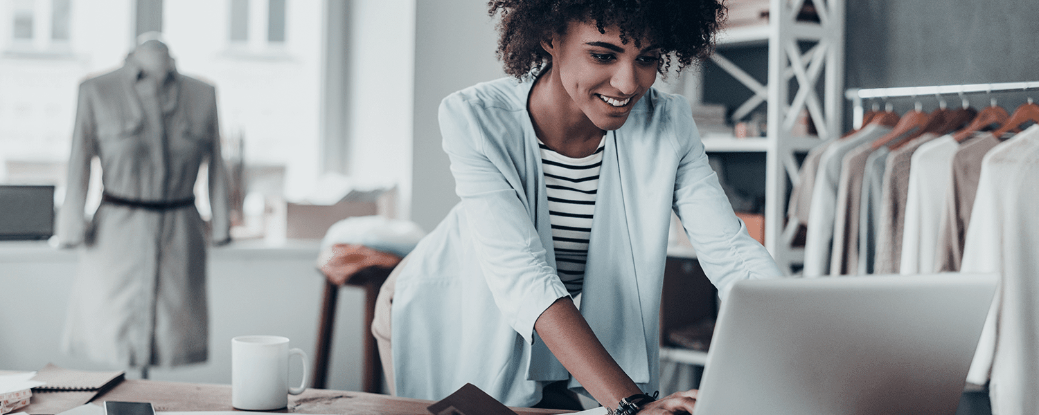 Package insurance: A woman smiling while looking at her laptop