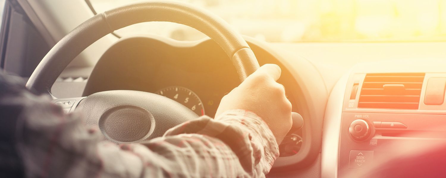 Personal motor insurance: Inside a car with a man behind the wheel. 