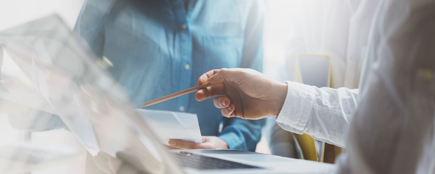 New ventures insurance: A man pointing with a pencil at a piece of paper.