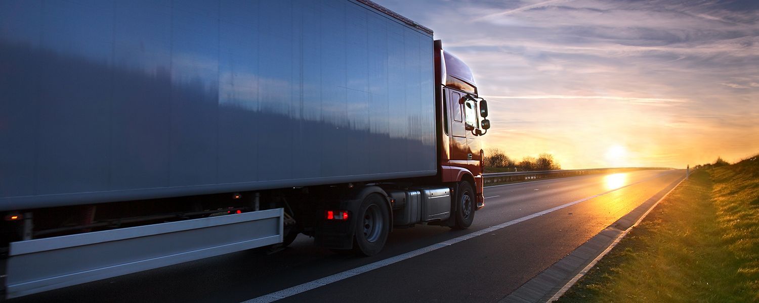 Transportation vehicles: A large truck driving on a road to deliver goods.