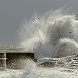 Case Study: A wave crashing against a barrier.
