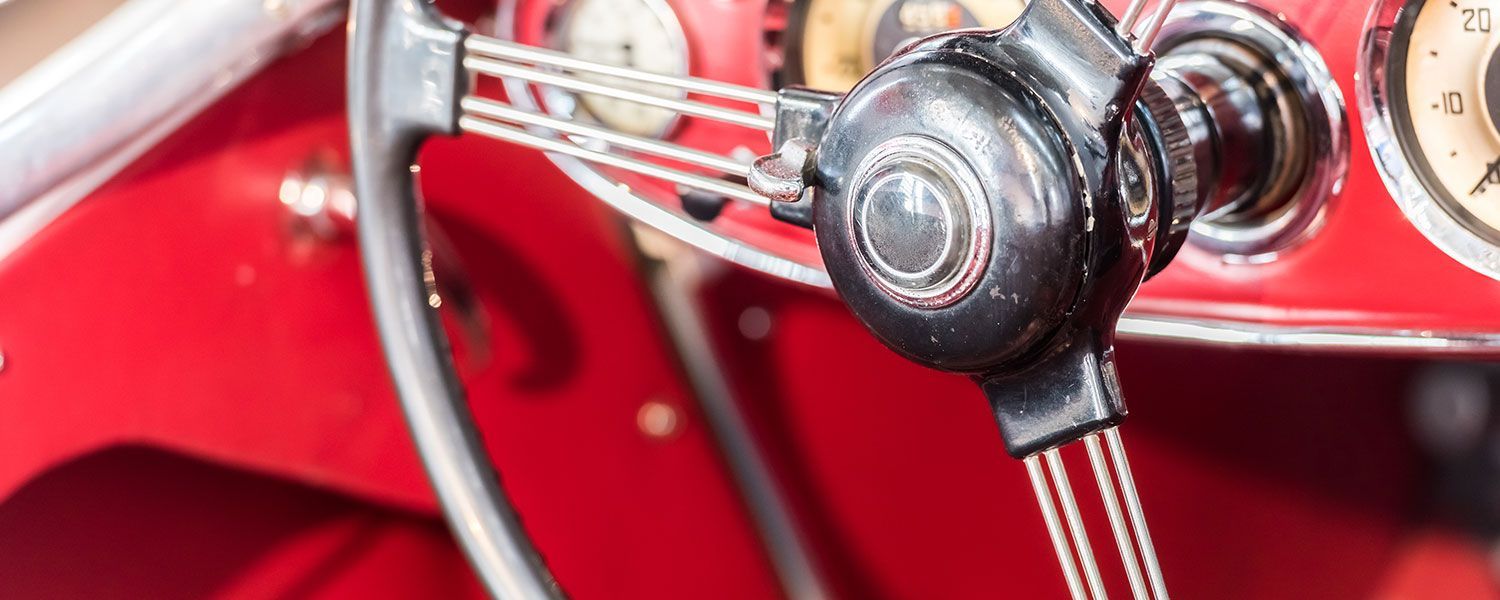  The vintage sports car club (VSCC) breakdown cover: Close-up of a red vintage car's wheel.